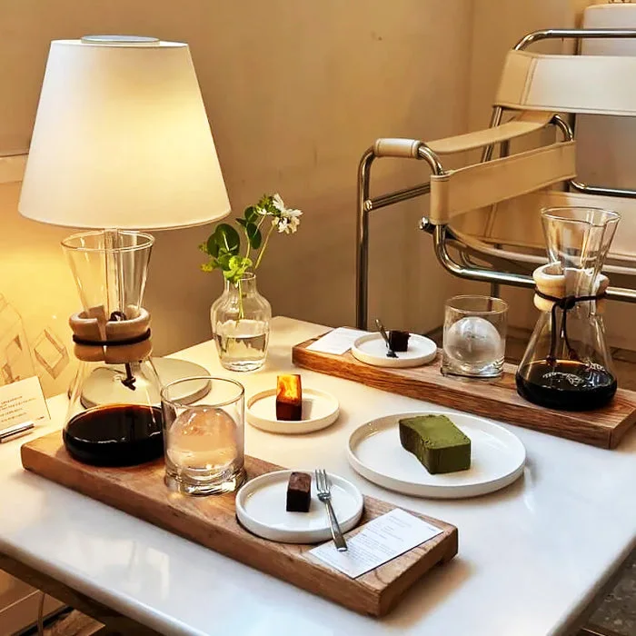 Filter coffee carafes, cups and desserts presented on wooden trays at 3F/LOBBY Yongsan.