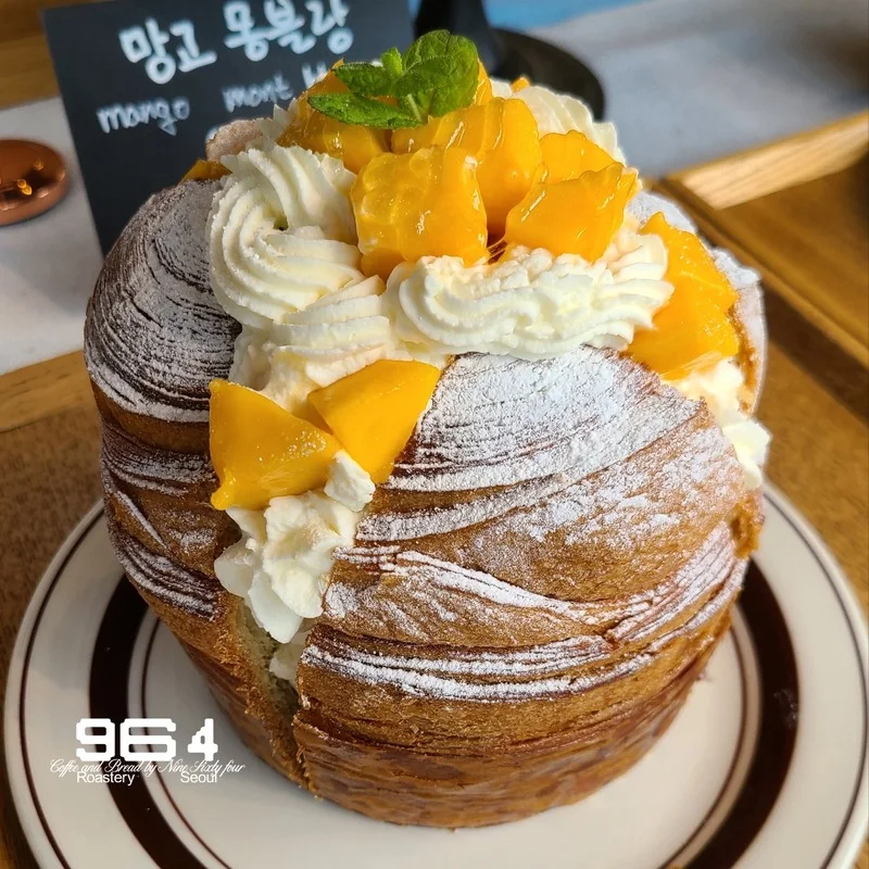 Mango-topped Mont Blanc pastry photographed for 964 Coffee’s Hoegi branch, with the original 964 watermark retained.