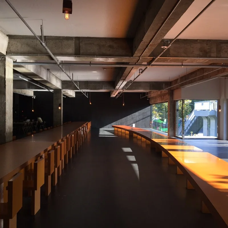 Light from broad windows falls across the dark counter and interior of Anthracite Yeonhui.