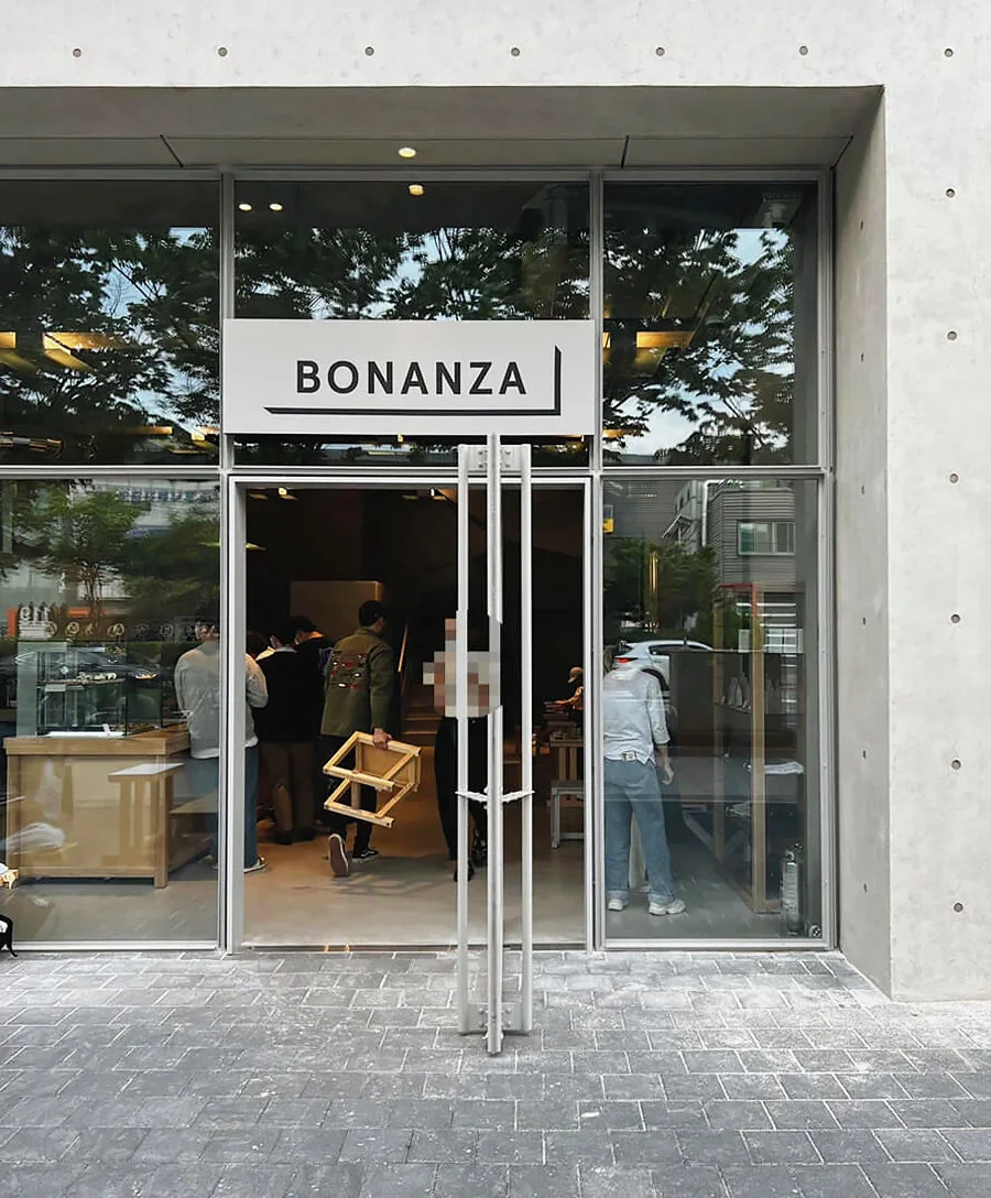 Wide glass and concrete entrance to Bonanza Coffee’s Gunja flagship.