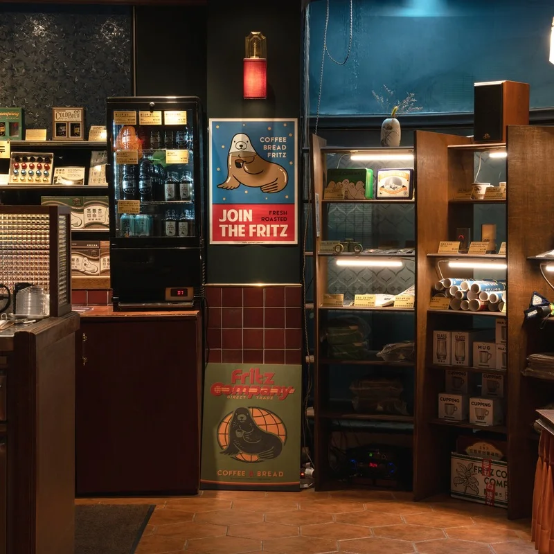 Warmly lit shelves, coffee equipment and Fritz merchandise inside the Yangjae café