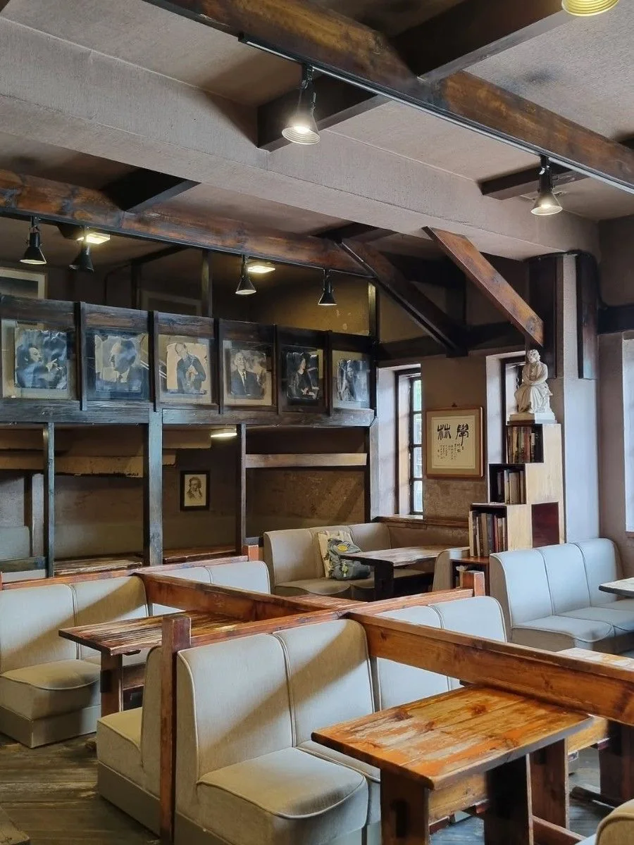 Wooden mezzanine, framed portraits and cream booths inside the original Hakrim café on Daehakro.