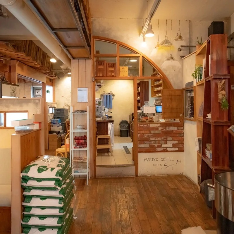 Wooden shelving and café seating inside second-floor Matisse Coffee in Sillim