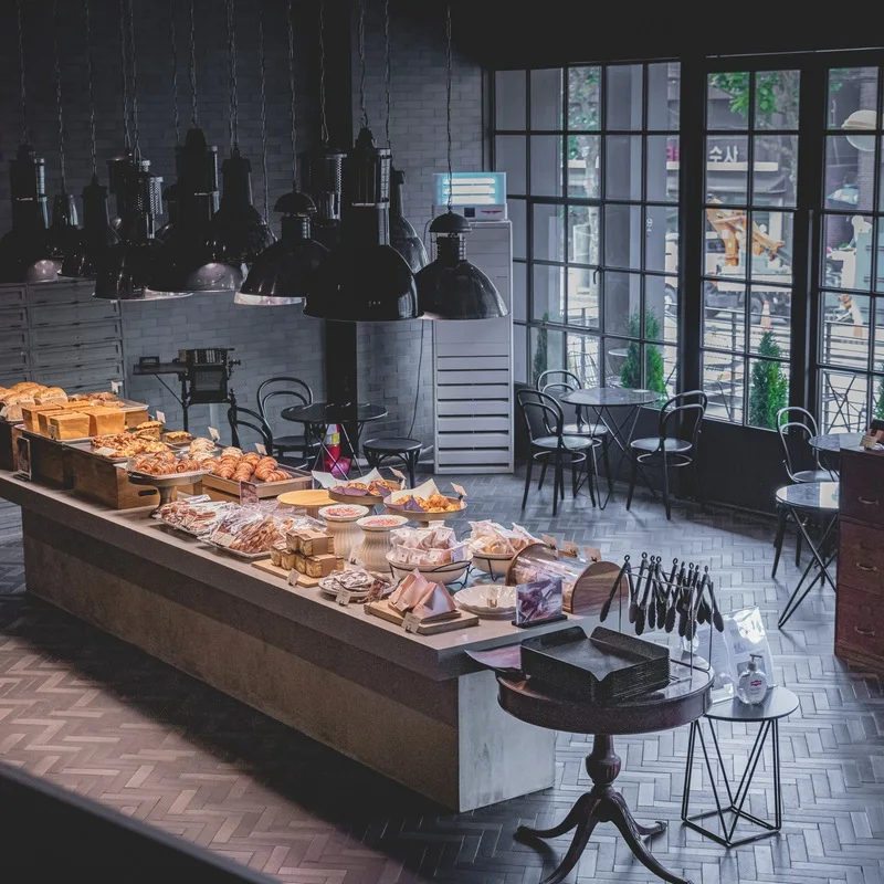 Bakery displays and hanging lights inside Noah's Roasting Yeonhui Heritage.