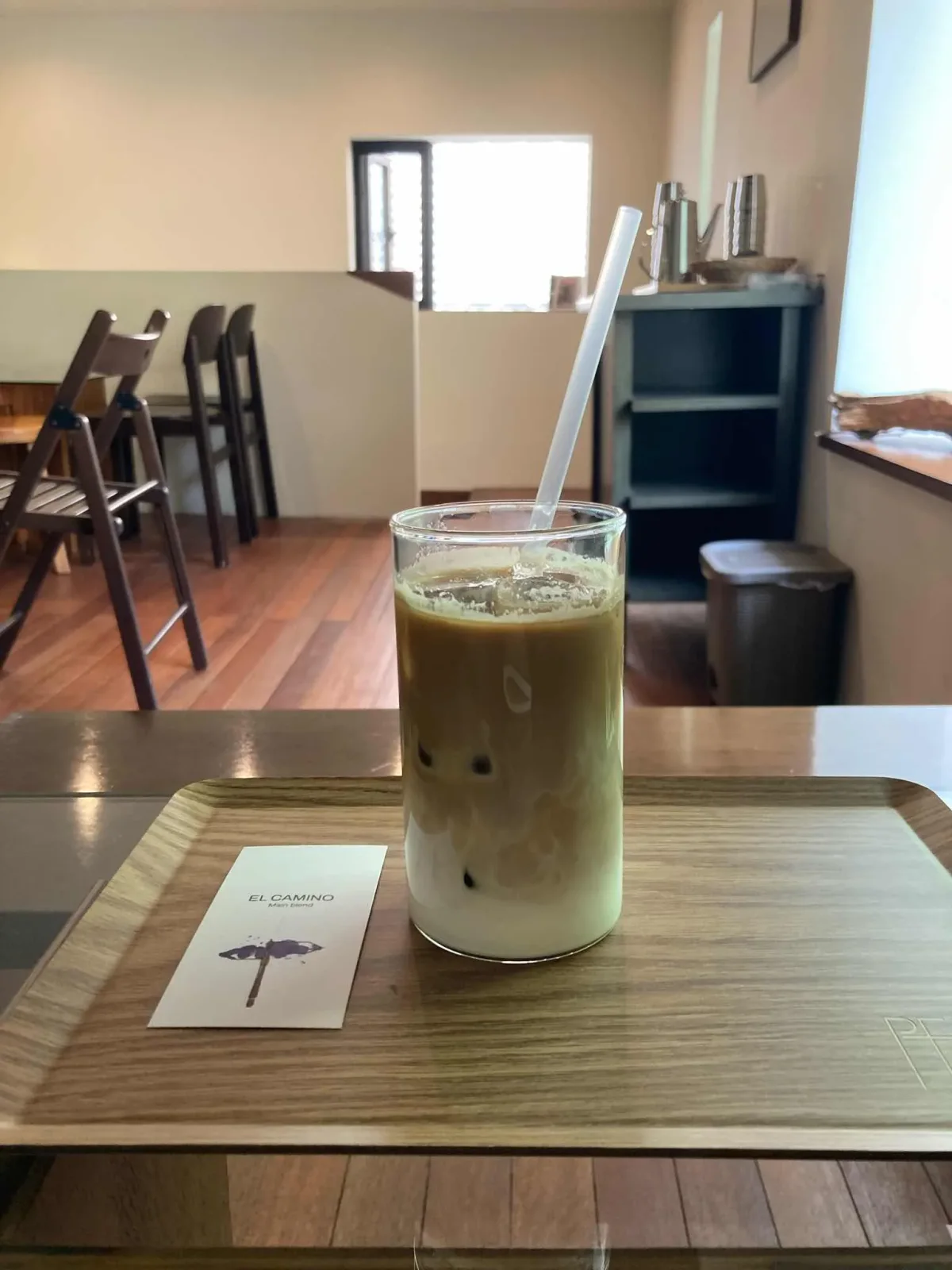 Iced milk coffee on a PEER tray with an El Camino blend card in the Gwanghuimun branch’s upstairs seating area.