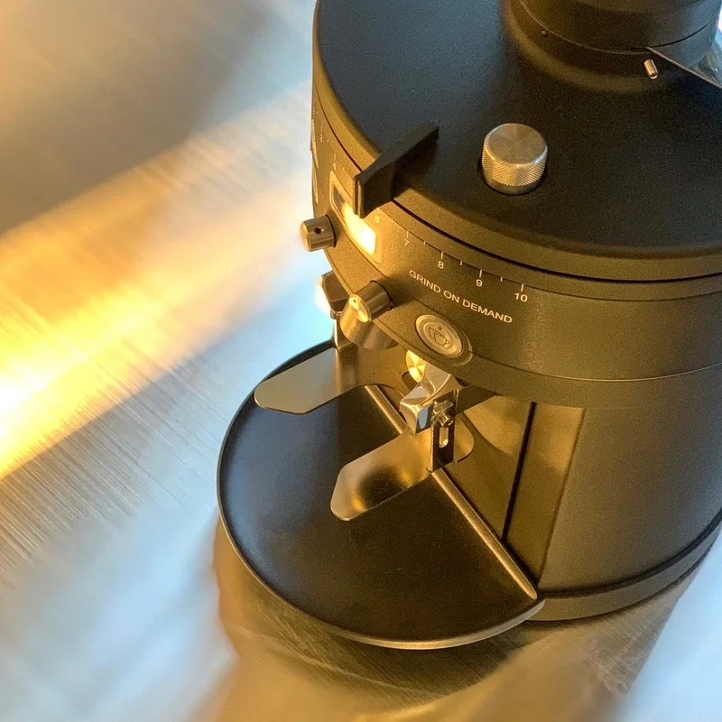 Sunlit espresso grinder and coffee equipment at Tapered Coffee Oksu.